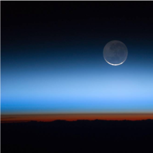 Aerial image of the Earth horizon and the moon in the distance