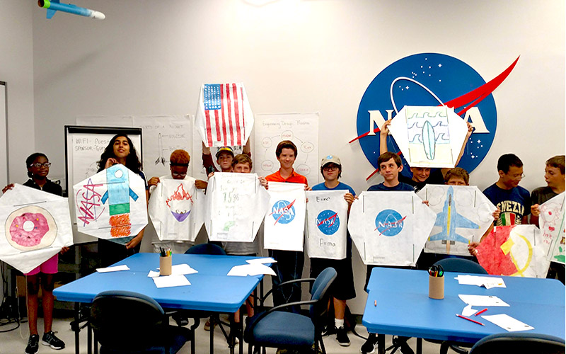 Students displaying kites they made