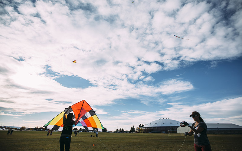 People preparing to launch a large kite
