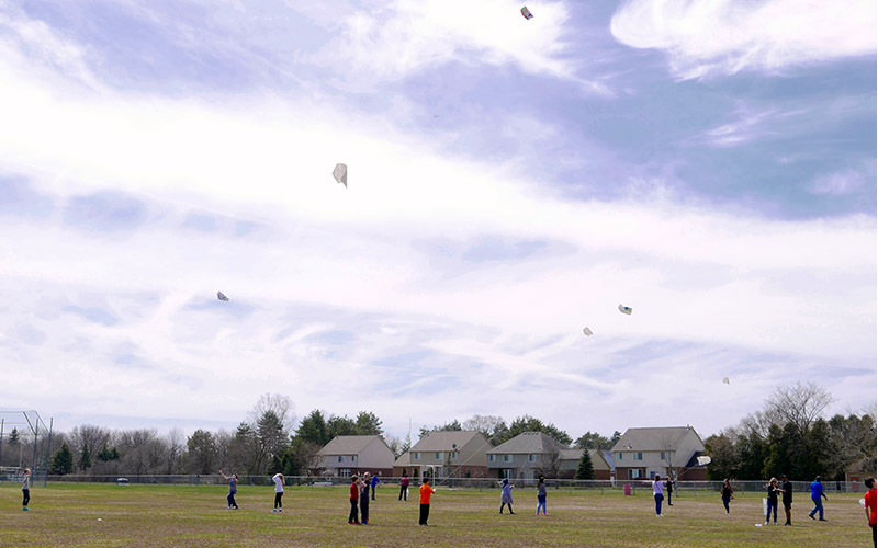Students flying small kites