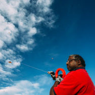 View of man flying kite (multiple kites in the air)
