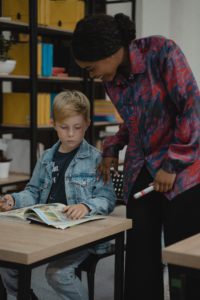 Image of a teacher helping a student