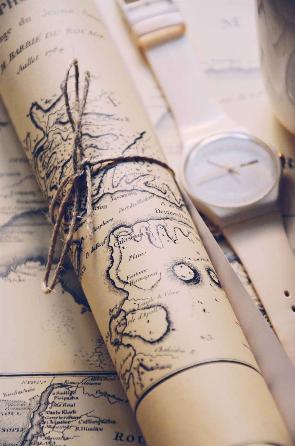 Image of an ancient map rolled up and tied with twine.